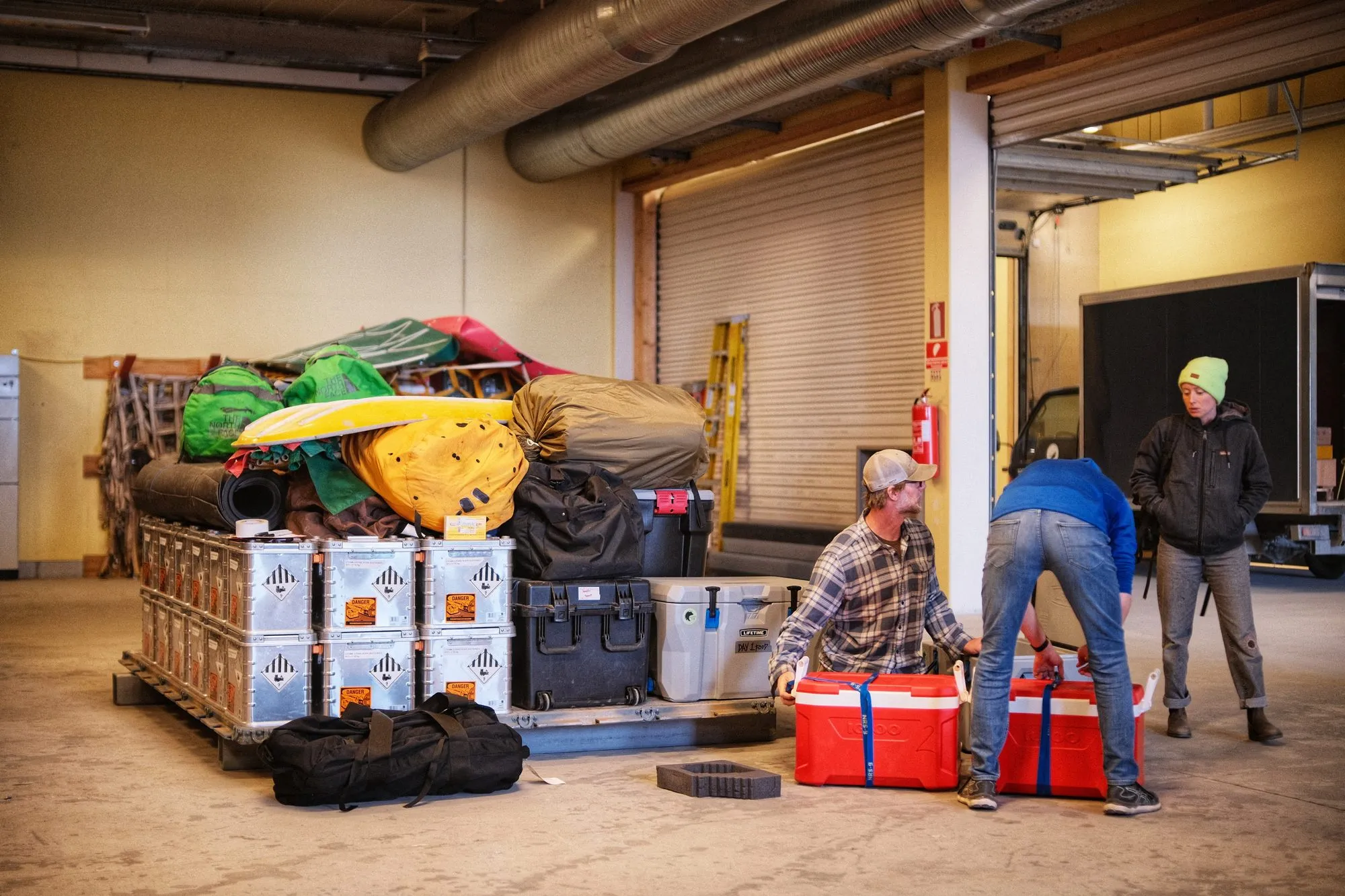 Checking out and inventorying the survival bags in the warehouse before the trip.